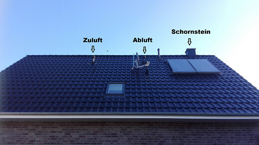 Roof of a house with supply and exhaust air openings as well as chimney
