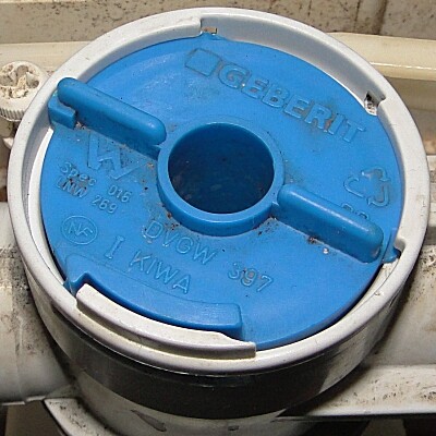 Blue Geberit cover cap on plumbing pipe as an installation plastic cover