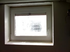 Small square window in a wall, interior view