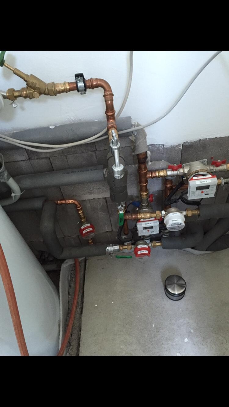 Concealed pipe installations with copper pipes, valves, and water meters