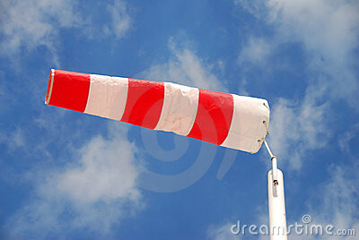 Barrier with red and white stripes against blue sky