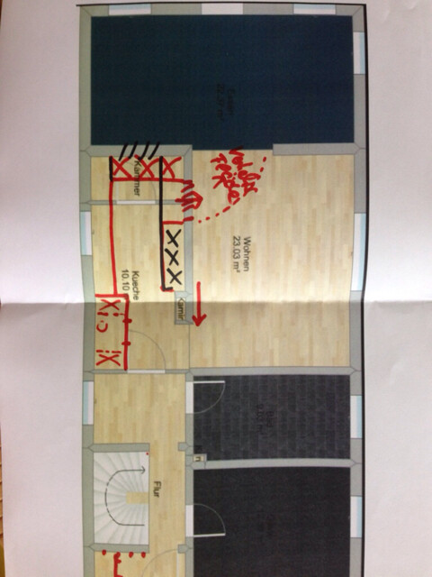 Floor plan of a house with hallway, kitchen and living area, red markings