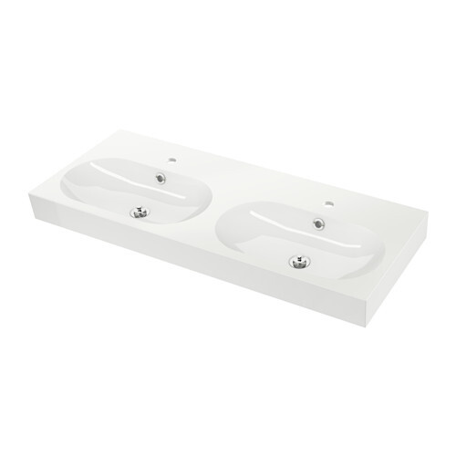 White double washbasin on bathroom countertop with two sinks