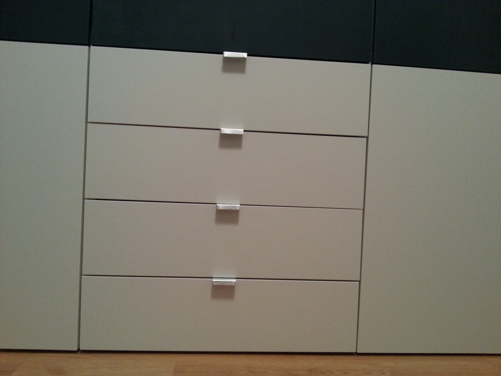 Bright modern cabinet with six flat drawers and silver handles