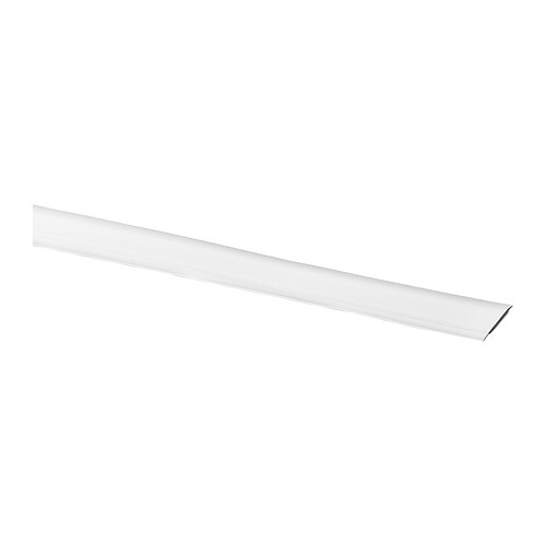 Long white plastic strip/cover, flat, slanting from bottom left to right.
