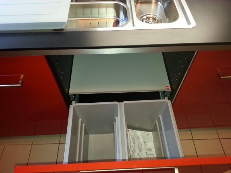 Kitchen: Sink on top, a pull-out drawer with two gray waste bins.