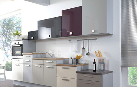 Modern kitchen with light fronts, dark countertop, and kitchen utensils on the wall
