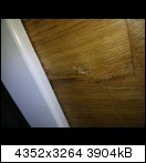 Close-up of wooden floor and white baseboard