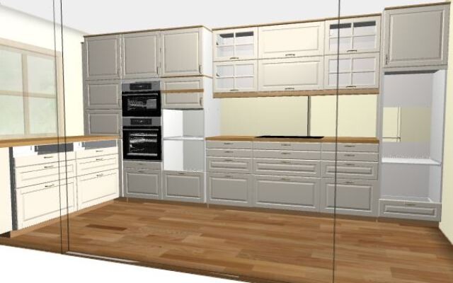 Modern kitchen unit with gray fronts, integrated ovens, refrigerator, and wood flooring.