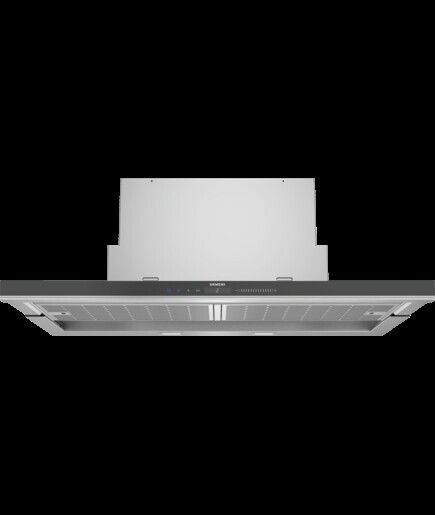 Modern extractor hood with chimney pipe, view from below onto kitchen area.
