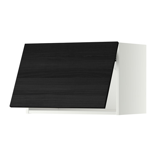 Dark kitchen base cabinet with black front in front of a light carcass, 3D render.