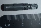Close-up of a black flashlight next to a tape measure on a dark background