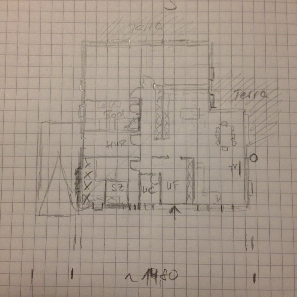 Hand-drawn floor plan sketch of a house on graph paper
