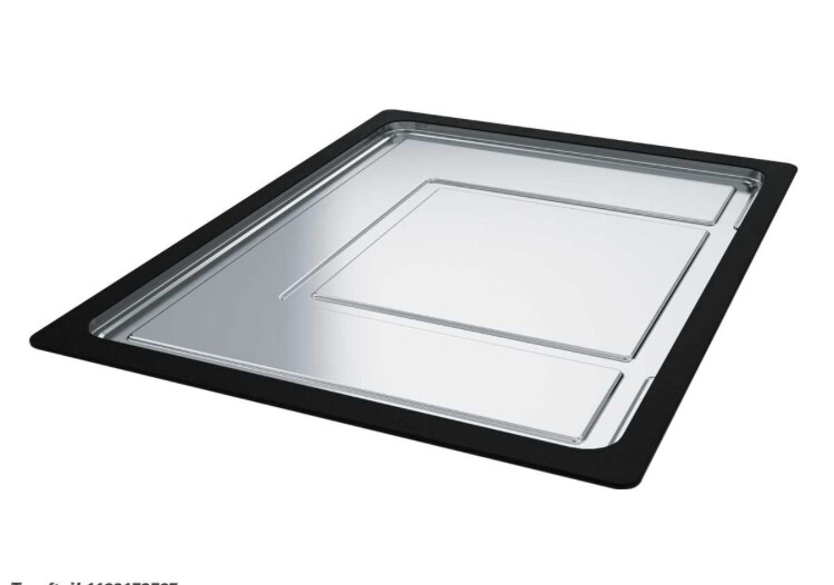 Rectangular metal baking tray with black rim and shiny interior.