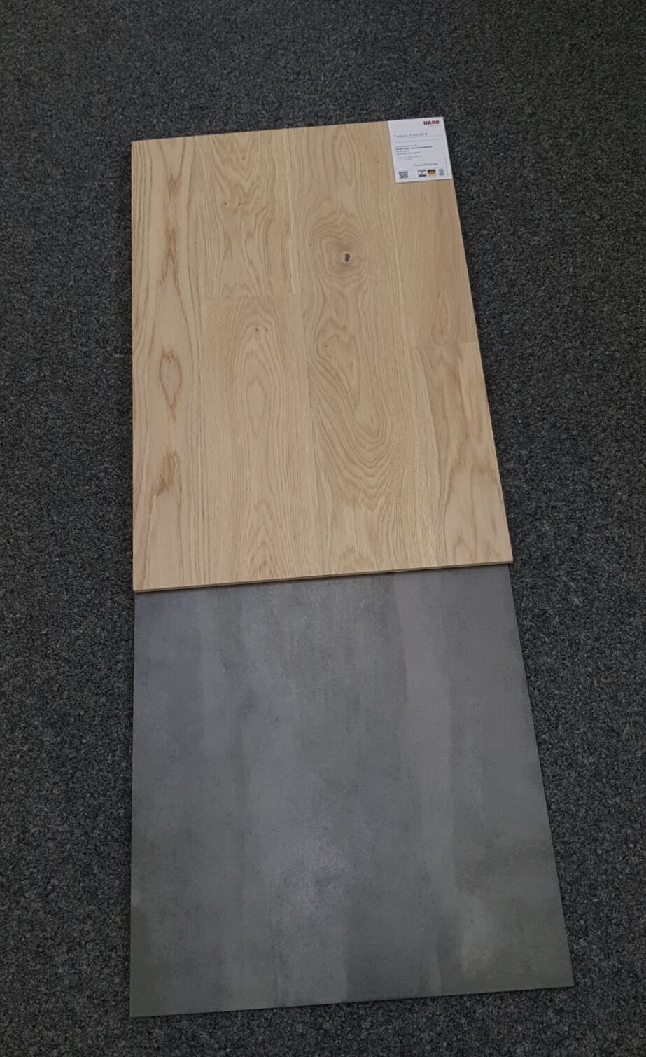 Wooden board with visible grain lies on gray floor tile; label top right.