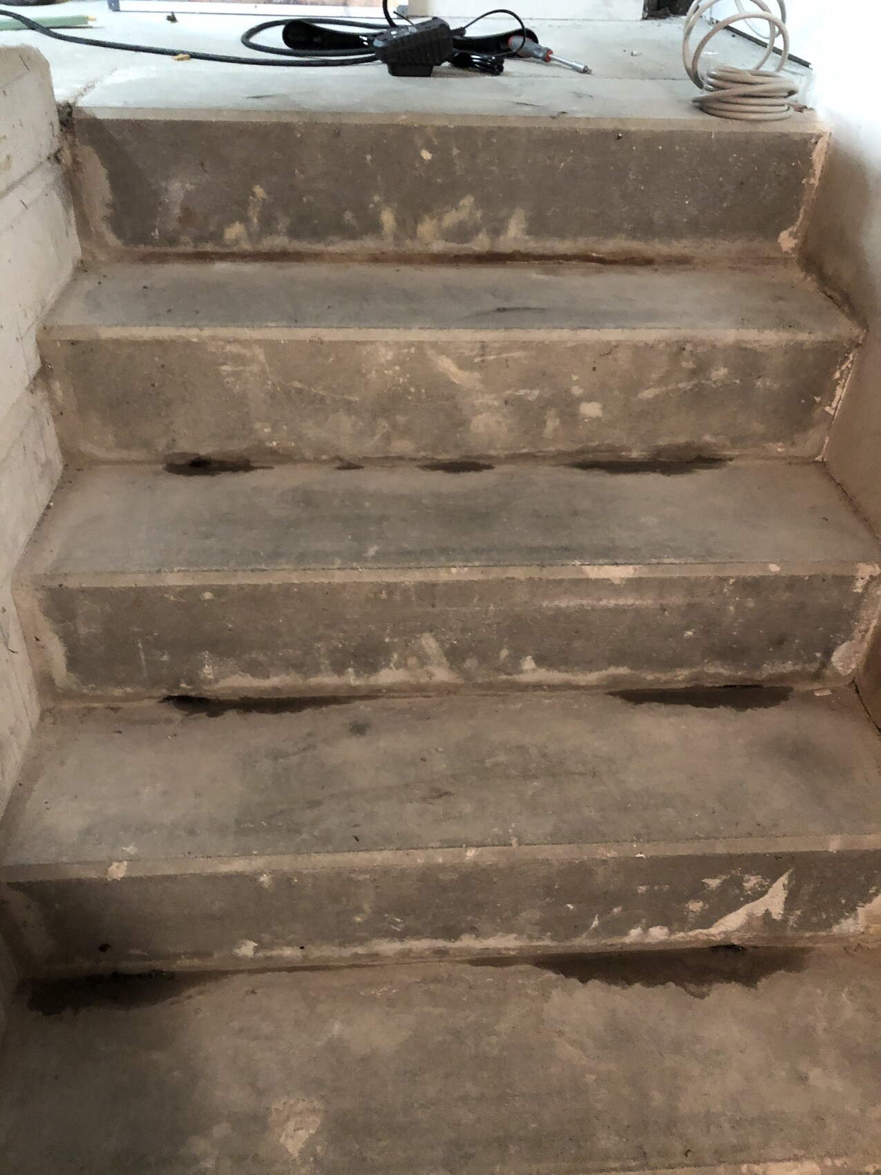 Concrete stairs in the shell construction phase at a building site, dusty and unfinished