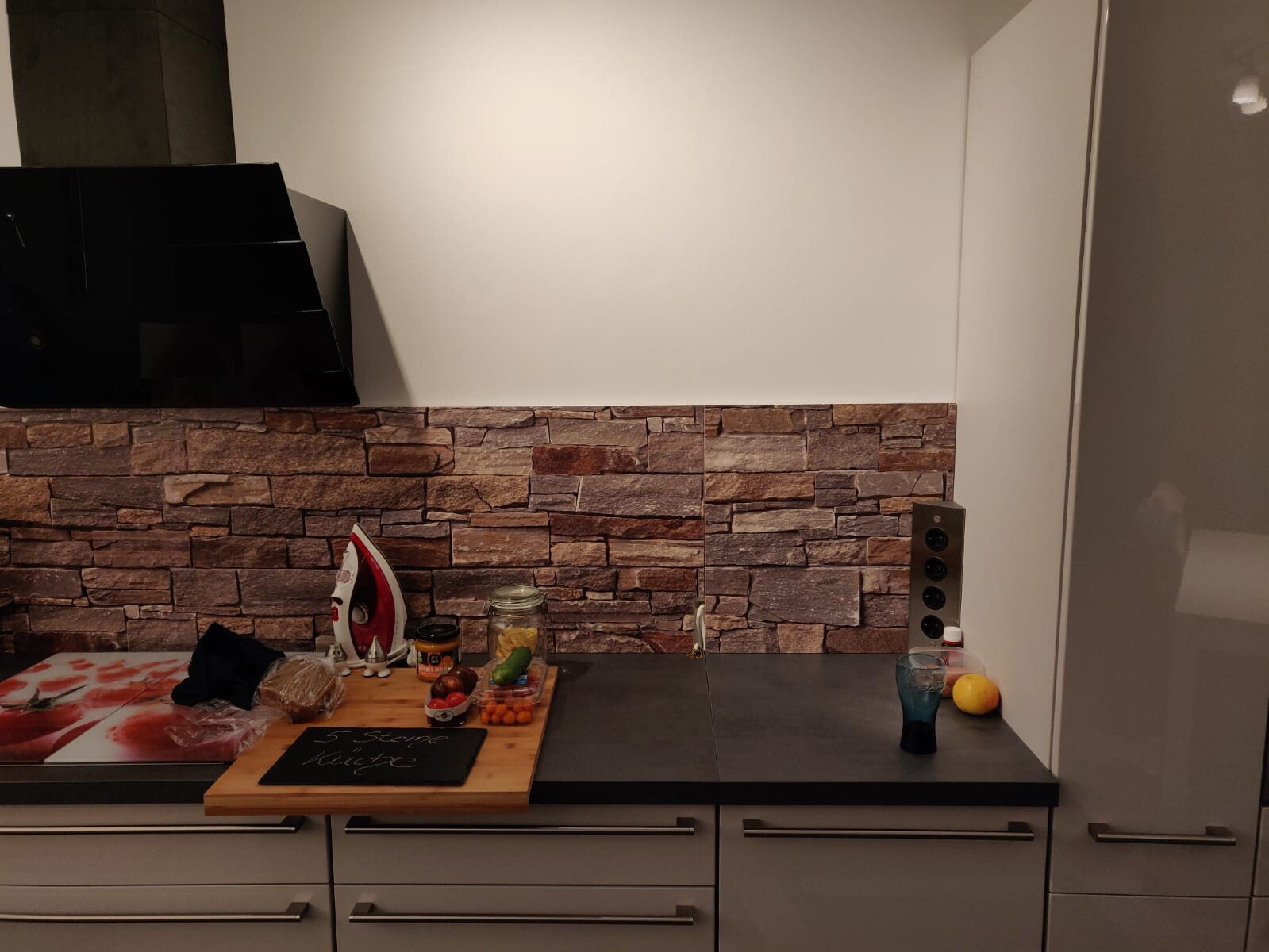 Modern kitchen with exposed brick wall, countertop and kitchen accessories