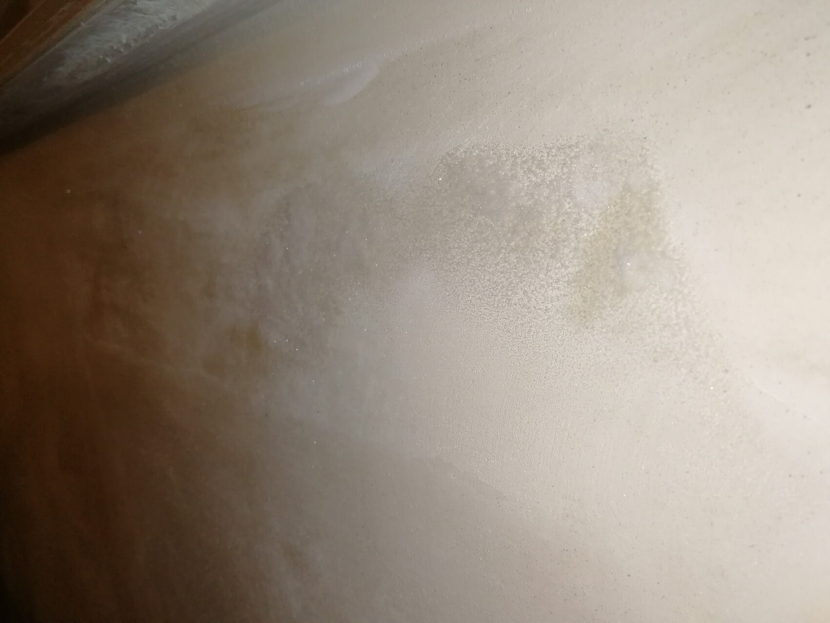Close-up of a rough interior wall surface with plaster residue