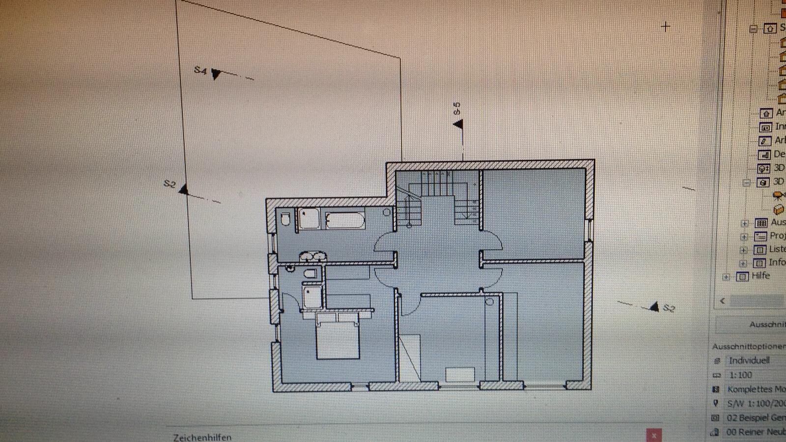 Floor plan of a residential house with central staircase, bedroom, bathroom, kitchen, and living room.