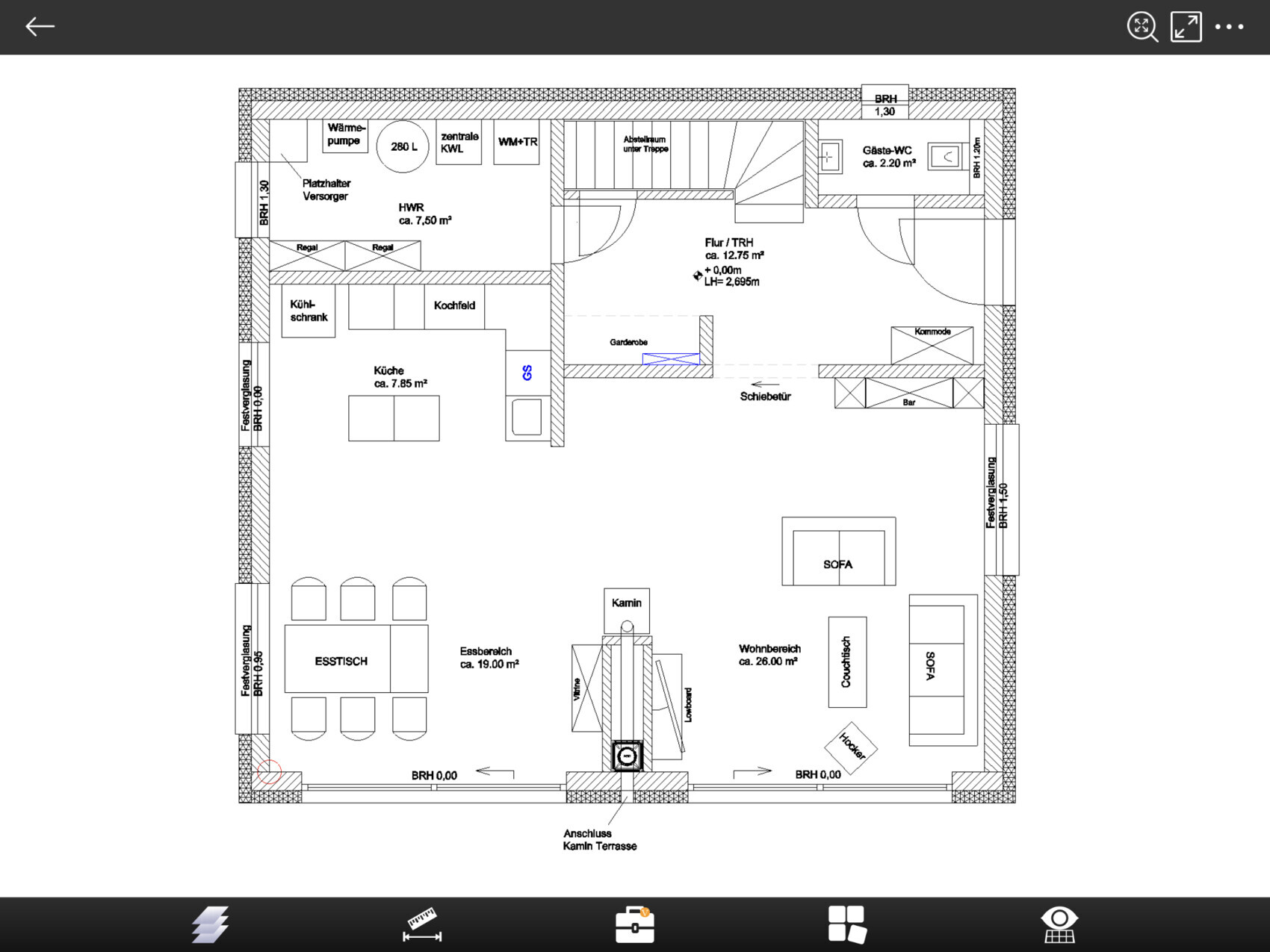 Open floor plan: kitchen on the left, dining area, living area with sofa and fireplace, stairs.