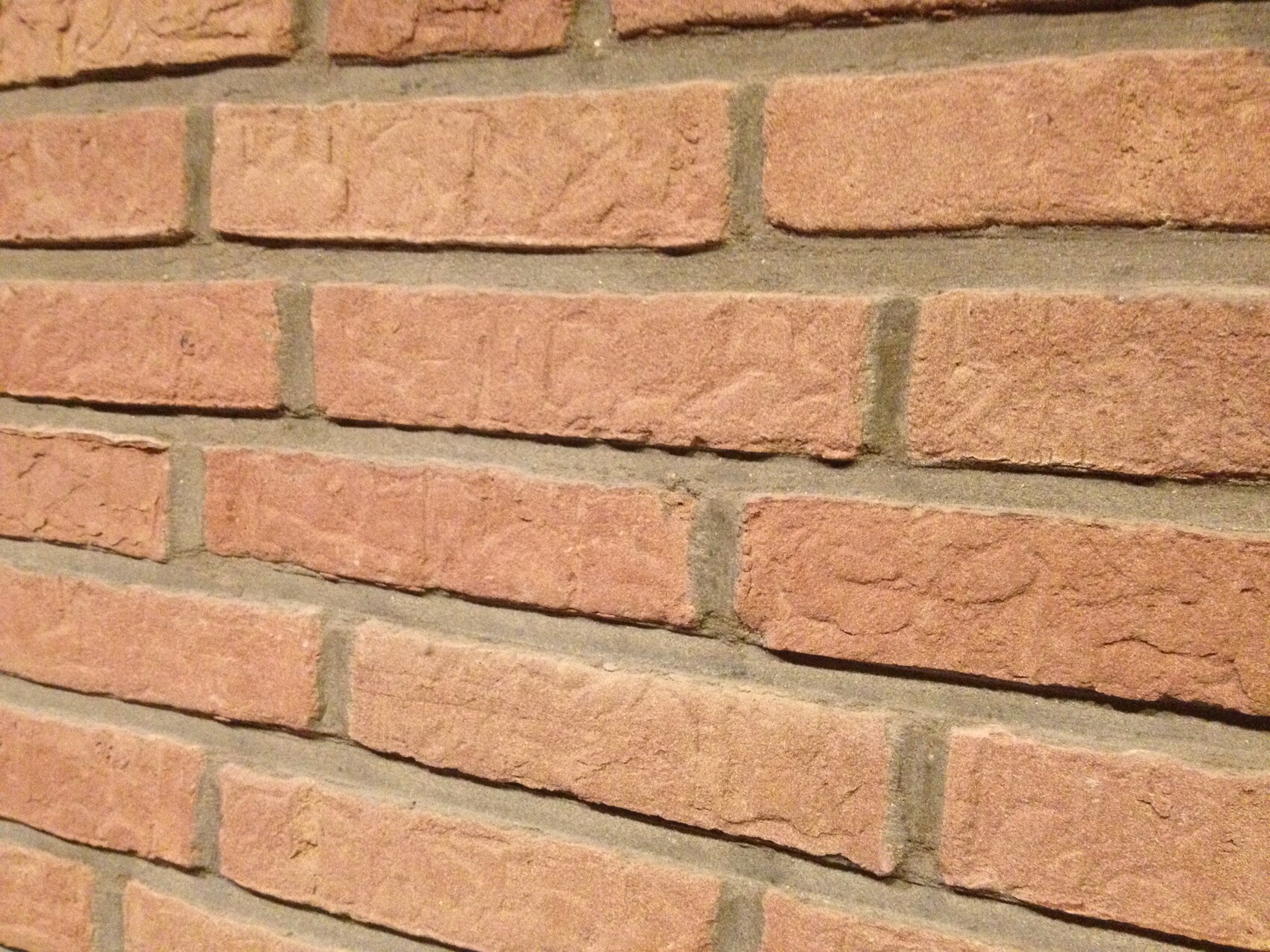 Close-up of a red brick wall as exterior cladding.