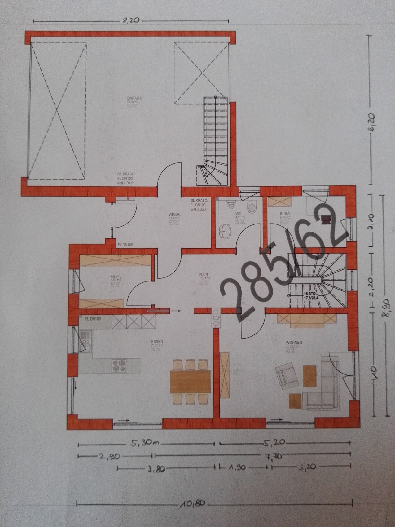 Floor plan of a house with living room, dining area, kitchen, garage and staircase.