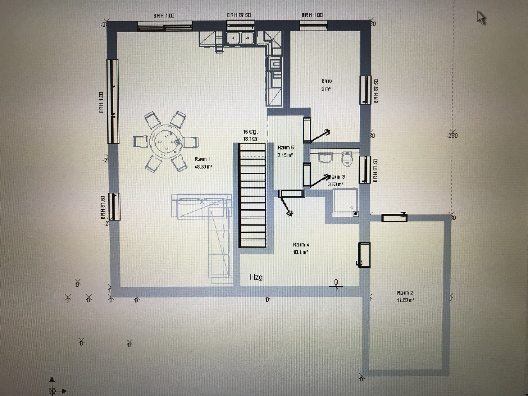Floor plan of a house: staircase in the center, living room with round dining table, kitchen and several rooms.