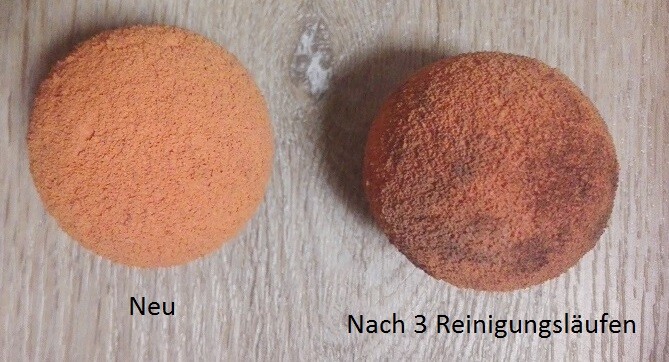 Two orange balls on wood surface, left new, right dirty after three cleaning runs