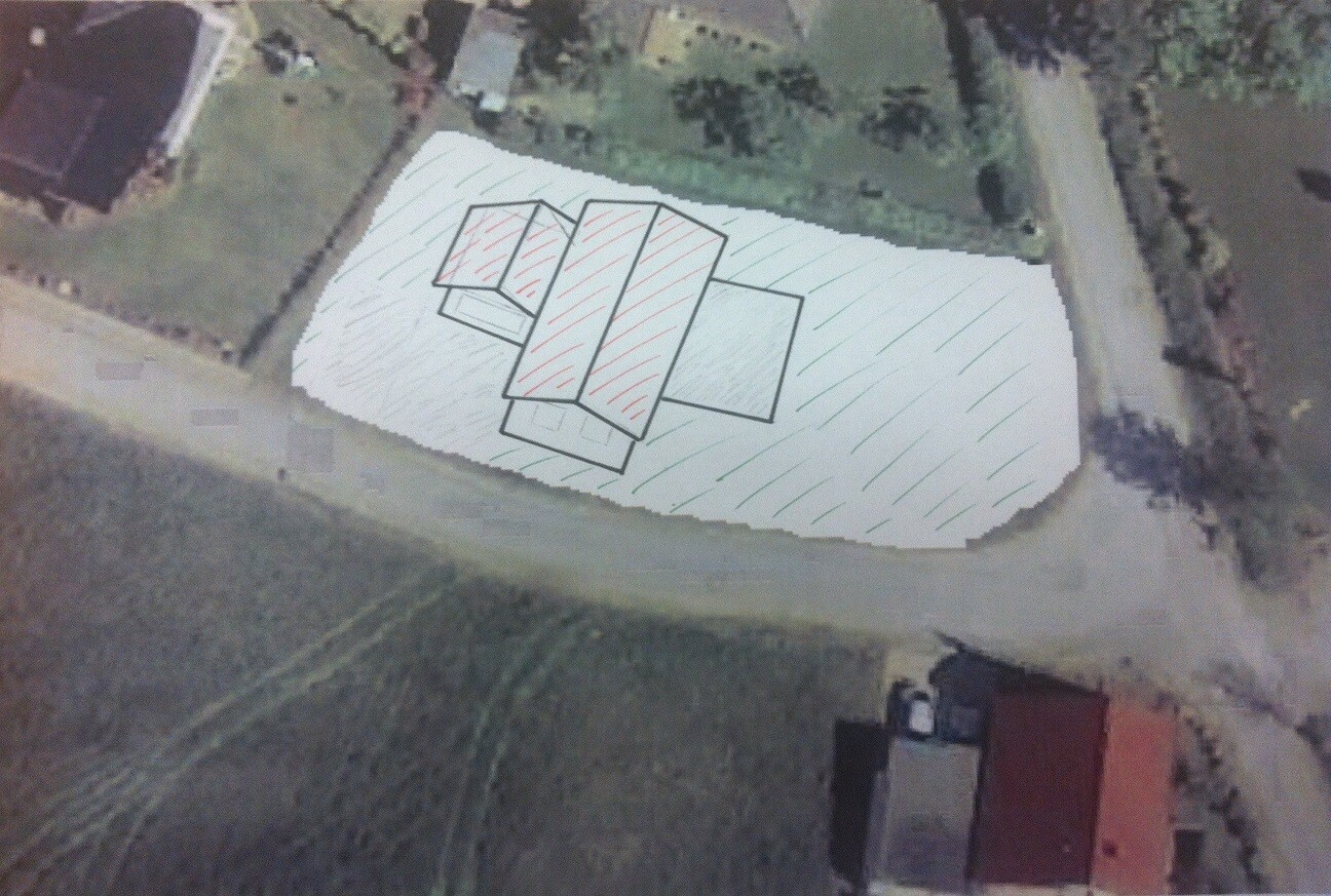 Aerial view: white surface with black rectangular sketches and red lines.