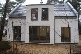 Modern white single-family house facade with large windows and entrance door