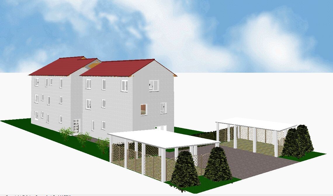 Multi-family house complex with red roof, carport, and garden area on green land.
