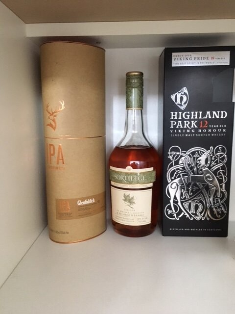 Whisky bottle next to packaging on a shelf