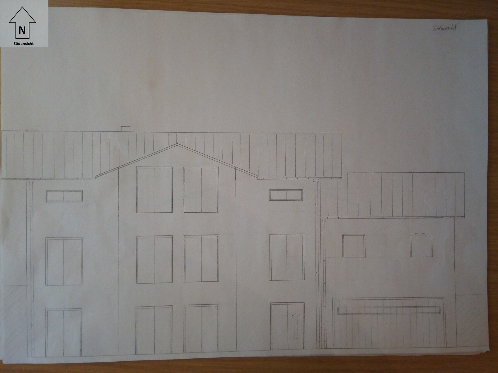 Architectural drawing of a multi-storey house front with roof windows, south view.