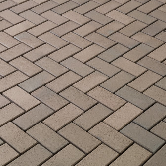 Paving stones in herringbone pattern, terrace or forecourt surface.