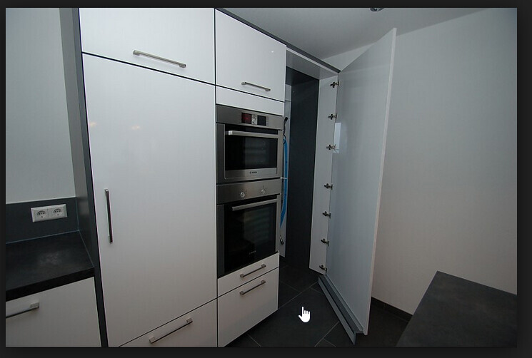 Kitchen with white fronts, built-in ovens, and open tall cabinet