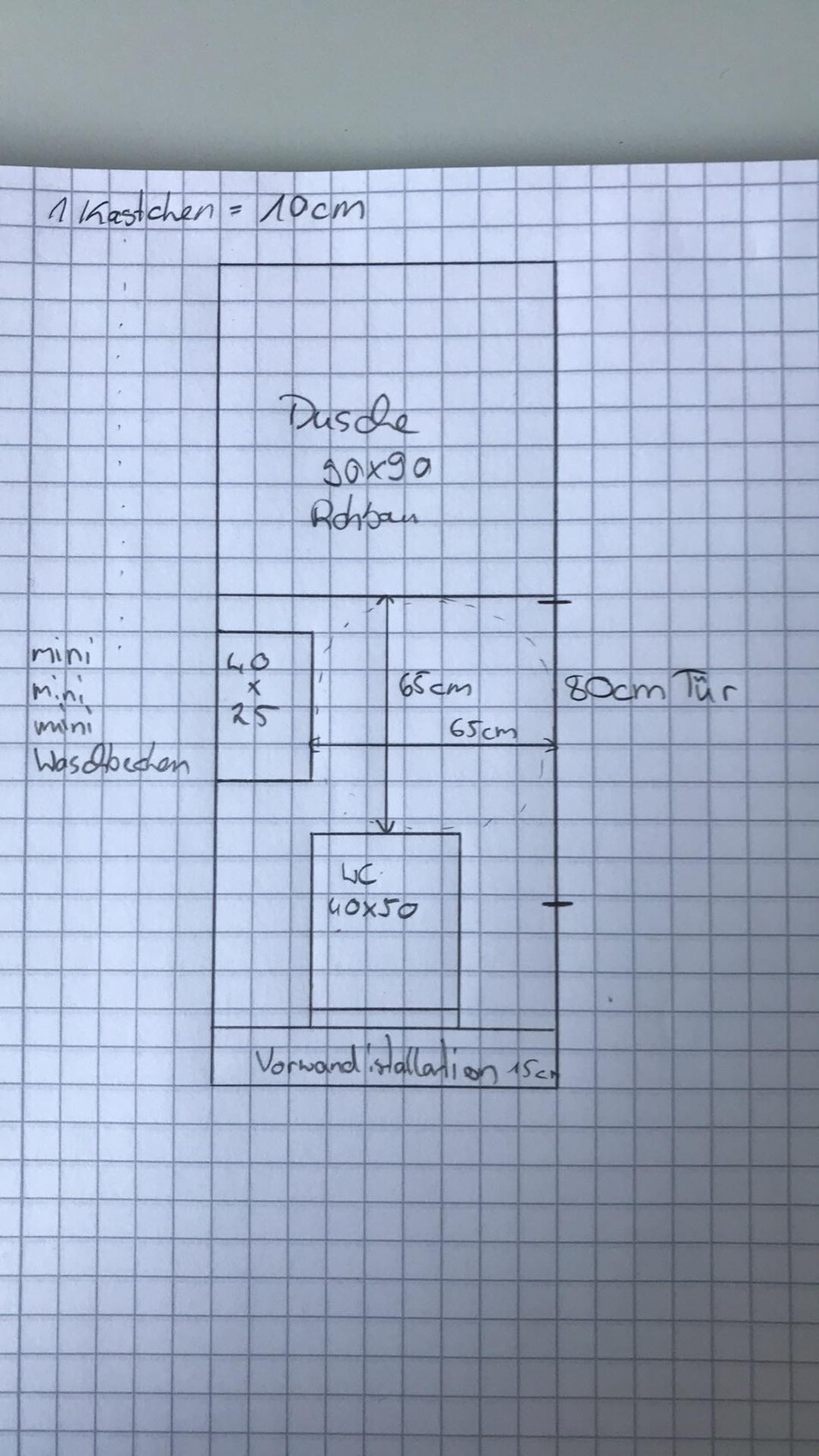Hand-drawn bathroom sketch with shower at the top and toilet at the bottom, dimensions 65/80 cm.