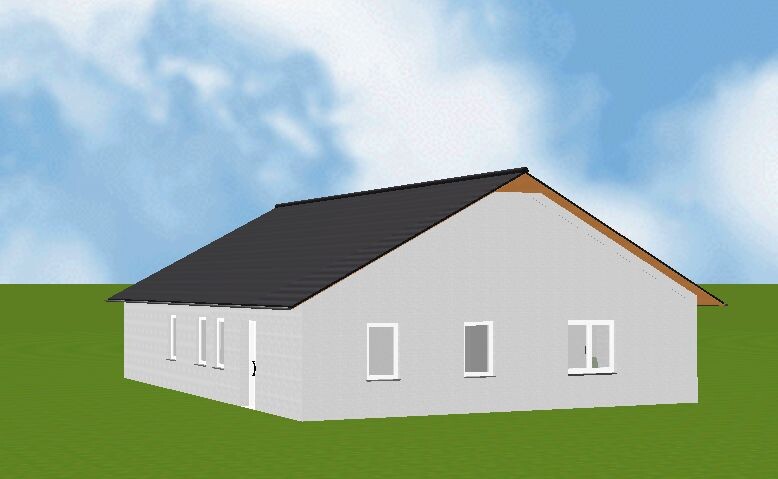 Gray single-family house with dark gable roof on green lawn under blue sky.