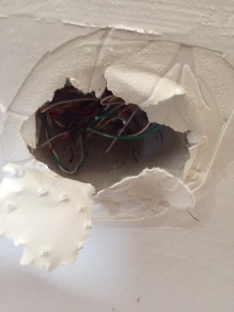 Open wall opening with exposed cables and electrical installation.