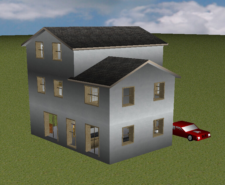 Multi-story gray house with several windows and red car next to it on grass