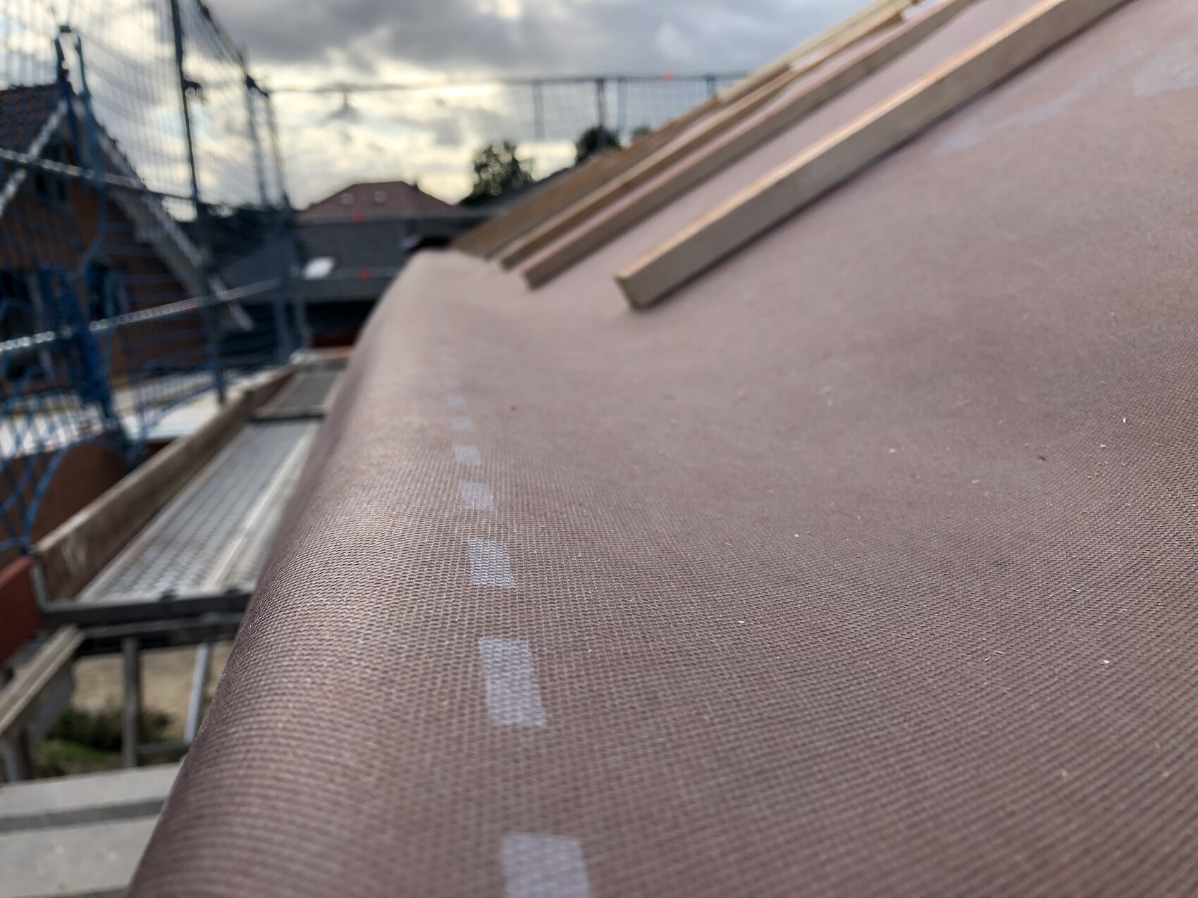 Close-up of a roof covered with roofing membrane at a construction site