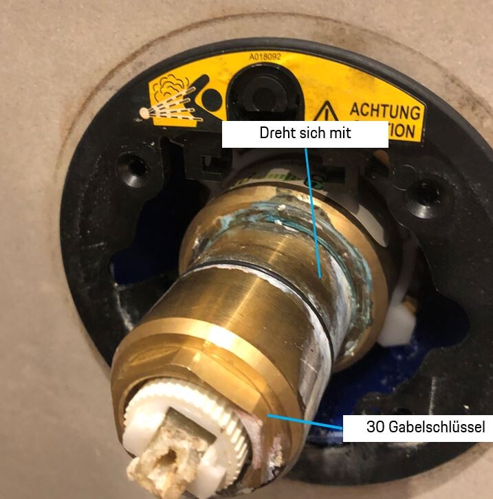 Close-up of a sanitary valve with a brass pipe in a bathroom installation.