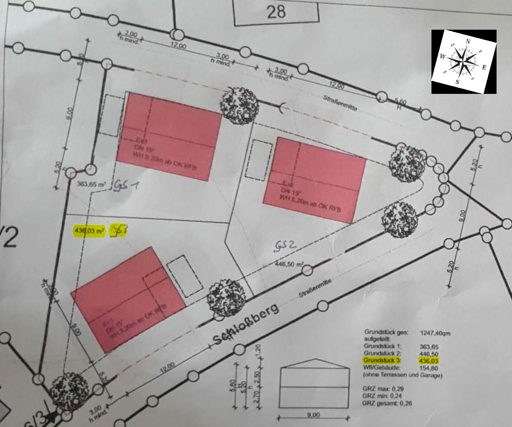 Site plan of a plot with three red buildings, trees, and dimension lines.