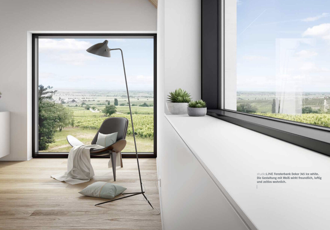 Modern interior with floor-to-ceiling window, lounge chair, floor lamp, and view of green landscape.