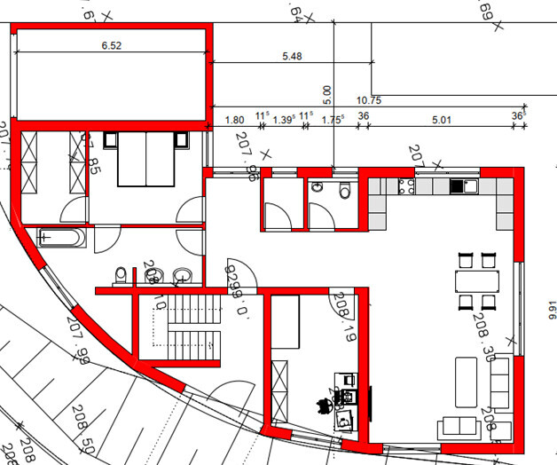 Floor plan of a building with red exterior walls; kitchen, dining area, living room, bathroom, stairwell.