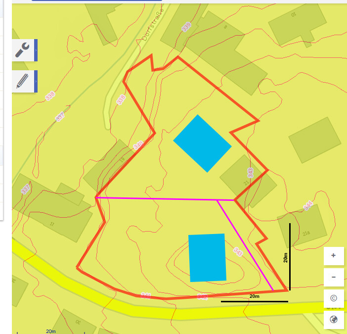 Map view of a plot with red outline, blue building areas, and pink access roads.