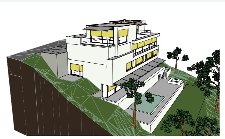 Modern white villa on a slope with terraces and trees