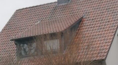 House roof with red roof tiles and dormer window