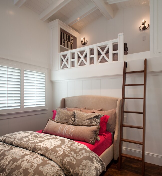 Bright bedroom with white loft, ladder, upholstered bed, and patterned ceiling.
