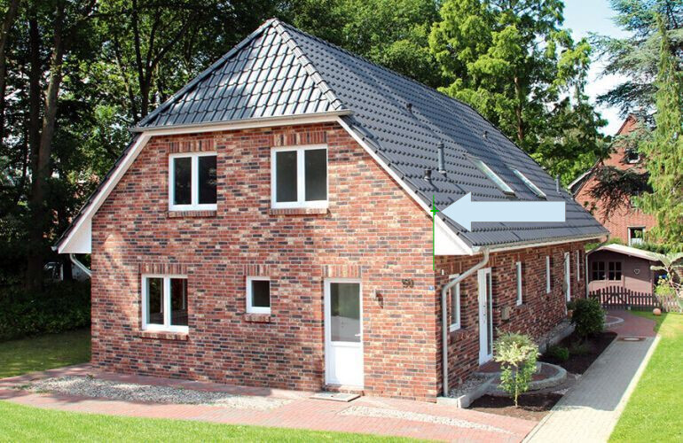 Two-story red brick house with a gray tiled roof, white windows, and garden.