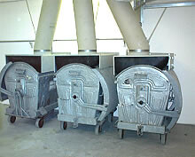 Several round ventilation fans with metal ducts in a building services installation